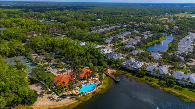 an aerial view of a houses with a yard
