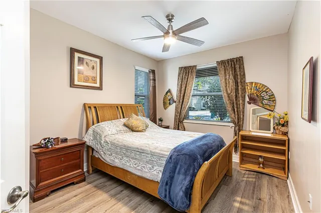 a bedroom with a bed and a large window with outer view