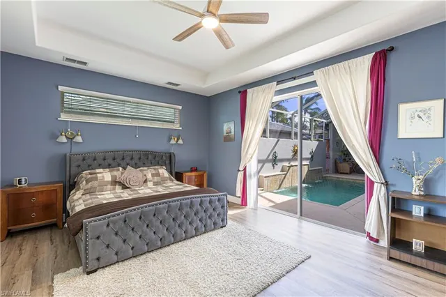 a bedroom with a bed and a ceiling fan