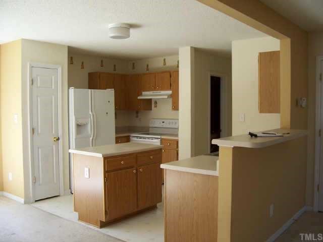 4836 Silverdene Street Raleigh, NC 27616 - Photo 2 of 9 a kitchen with a refrigerator sink and stove