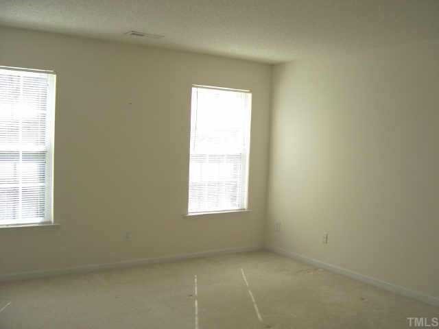 4836 Silverdene Street Raleigh, NC 27616 - Photo 8 of 9 an empty room with a window