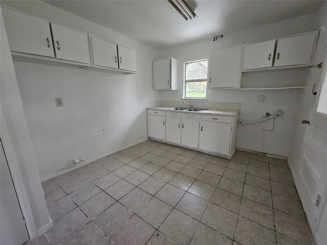 a kitchen with cabinets and window
