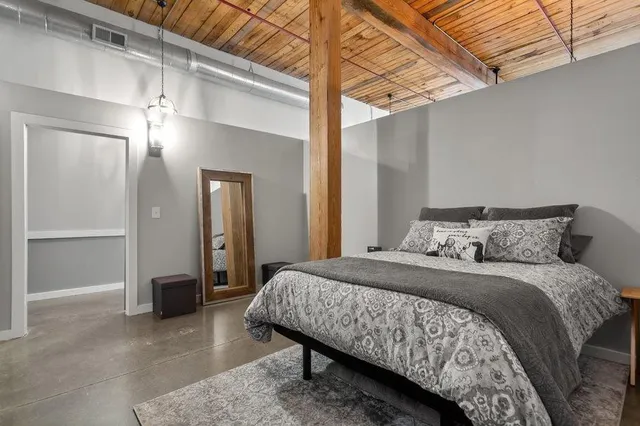 a bedroom with a bed and a chandelier