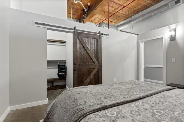 a bedroom with a bed and a television