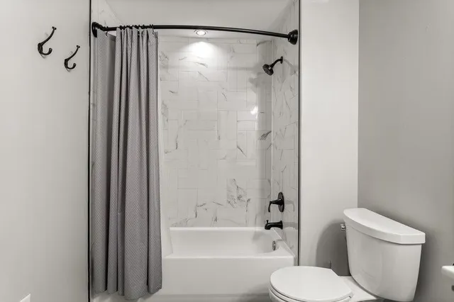 a bathroom with a toilet and shower