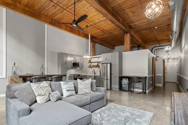 a living room with furniture and a chandelier