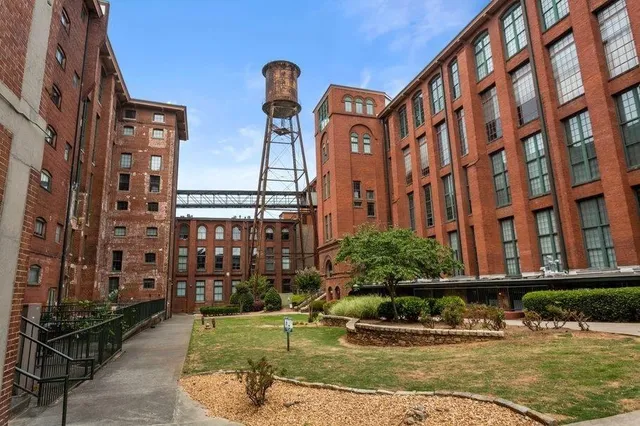a view of a white house with a sink and yard