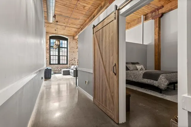 a view of a hallway with a couch and a window