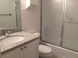 11206 Southwest 125th Place, Unit 11206 Miami, FL 33186 - Photo 6 of 15 a bathroom with a granite countertop sink toilet and shower