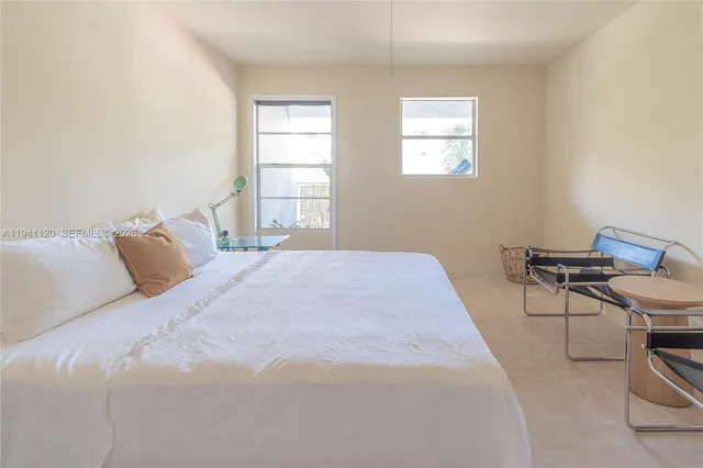 a bedroom with a bed a table and chair