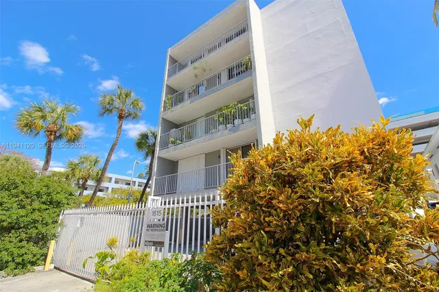 a view of a multi story building in front of house