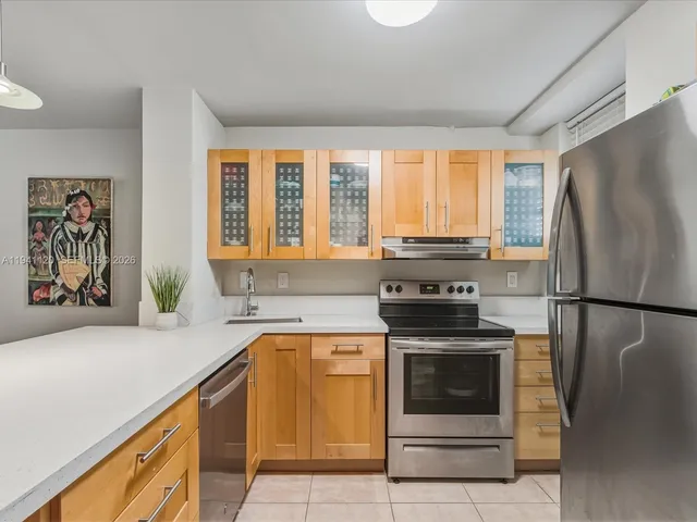 a kitchen with a stove a refrigerator and a sink