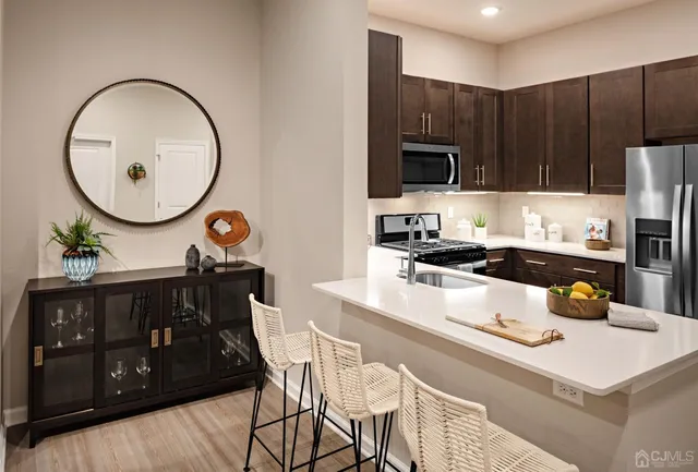 a kitchen with wooden cabinets and stainless steel appliances