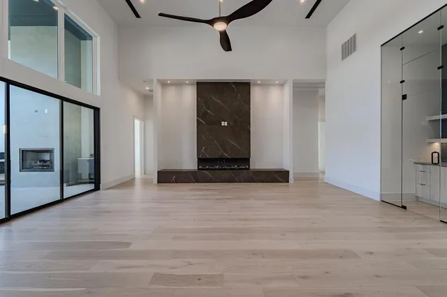 a view of a hallway with wooden floor and cabinet