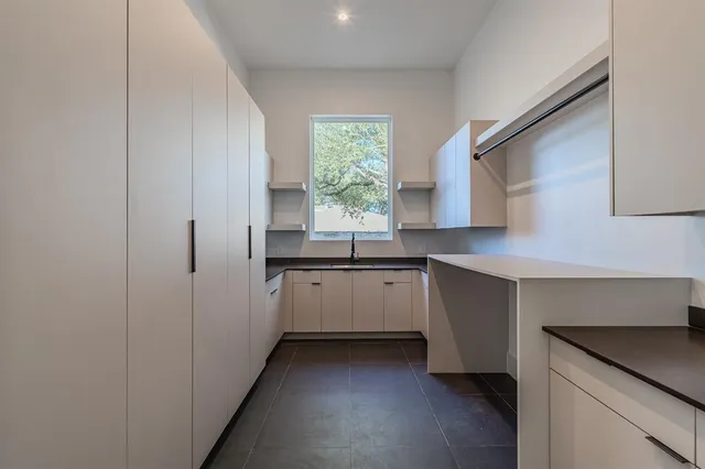 a kitchen with granite countertop white cabinets and white appliances