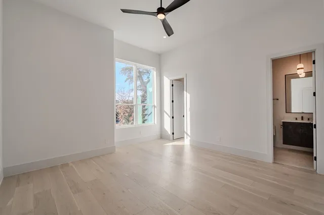 a view of a room with wooden floor and windows