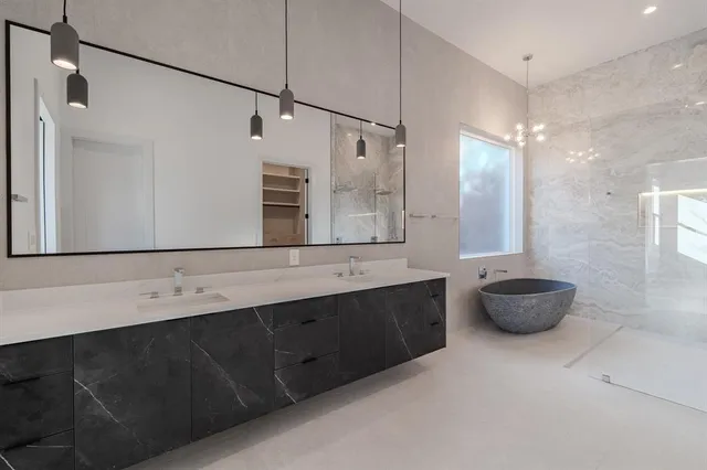 a bathroom with a double vanity sink and mirror