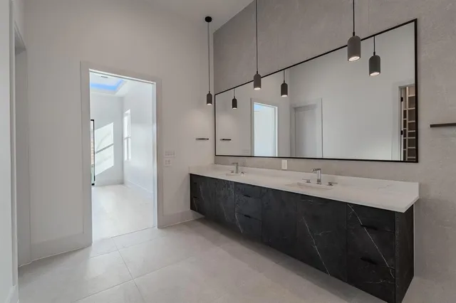 a bathroom with a double vanity sink and mirror