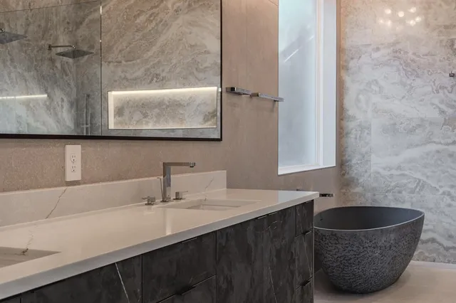 a bathroom with a sink a mirror and a bathtub