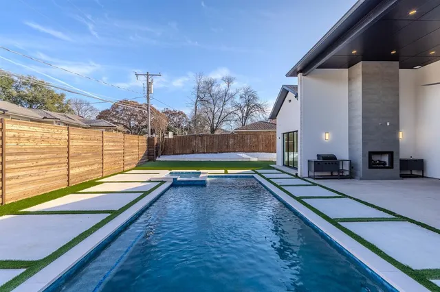 a view of a swimming pool with a patio
