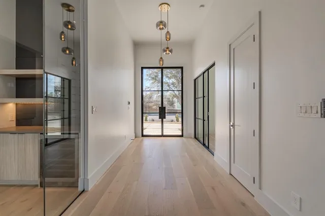 a view of hallway with wooden floor