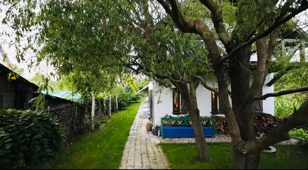a view of a house with a backyard and a garden