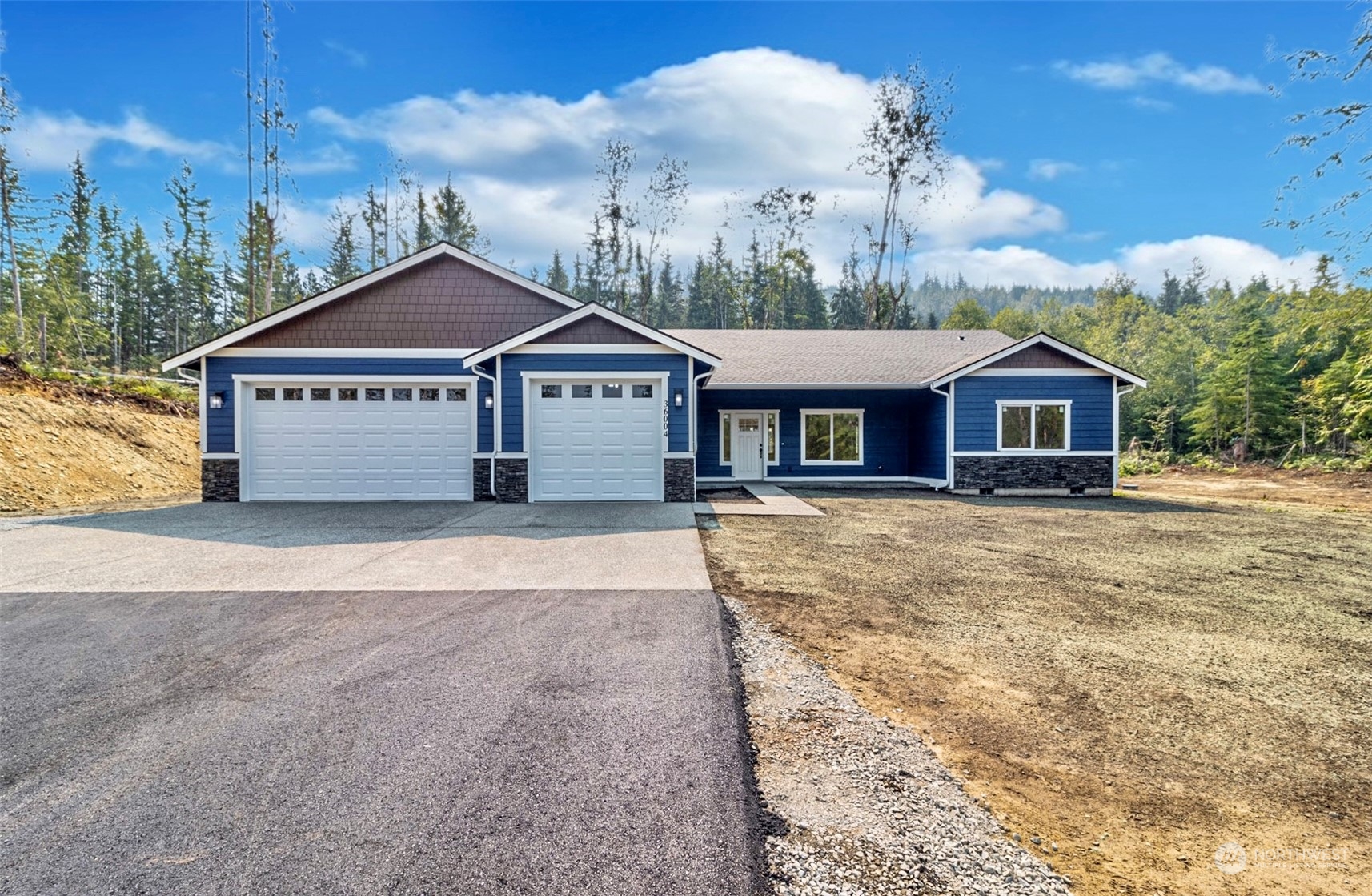 36004 Mann Road Sultan, WA 98294 - Photo 1 of 1 a front view of a house with a garden and trees