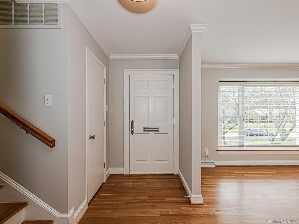 5706 Telfair Road Charlotte, NC 28210 - Photo 2 of 37 a view of a hallway with wooden floor and a window