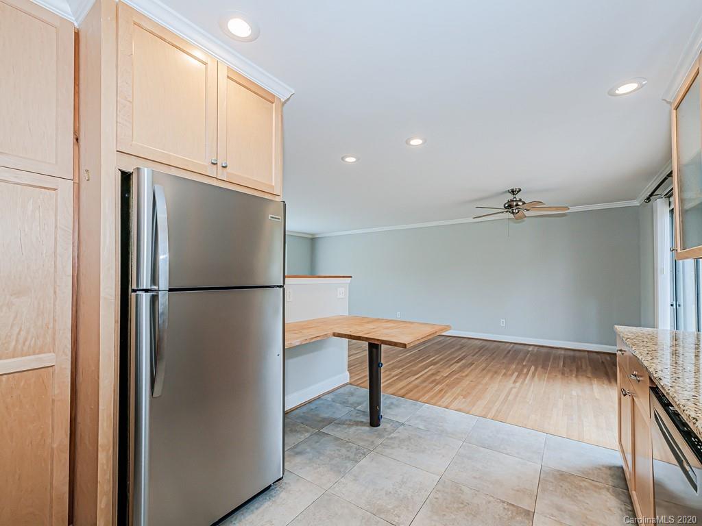 5706 Telfair Road Charlotte, NC 28210 - Photo 11 of 37 a kitchen with a refrigerator and countertop