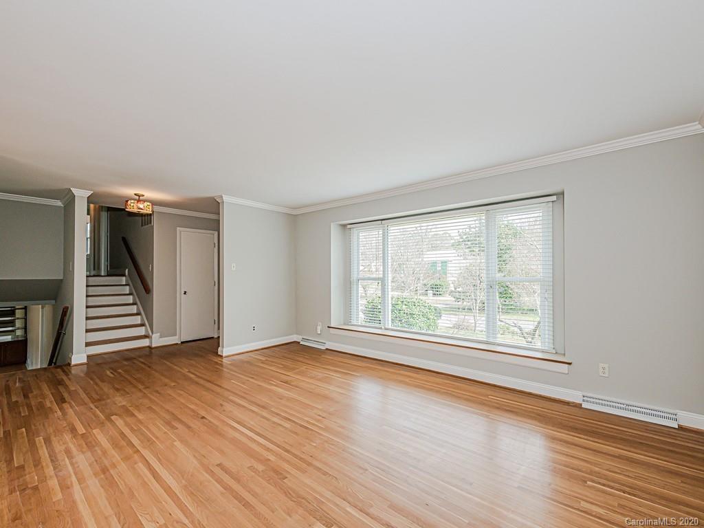 5706 Telfair Road Charlotte, NC 28210 - Photo 14 of 37 a view of an empty room with a window and wooden floor
