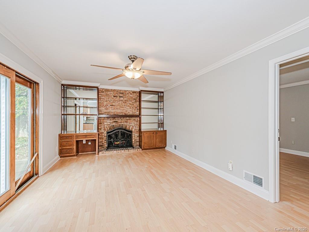 5706 Telfair Road Charlotte, NC 28210 - Photo 18 of 37 an empty room with furniture and a fireplace
