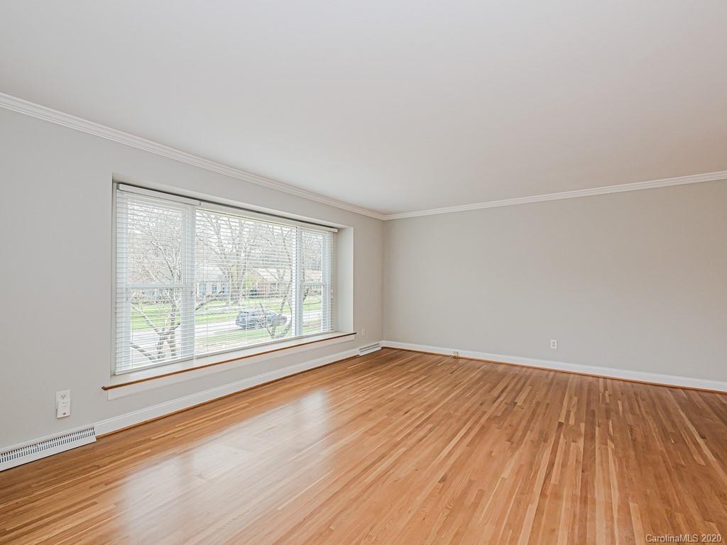 5706 Telfair Road Charlotte, NC 28210 - Photo 3 of 37 an empty room with wooden floor and windows