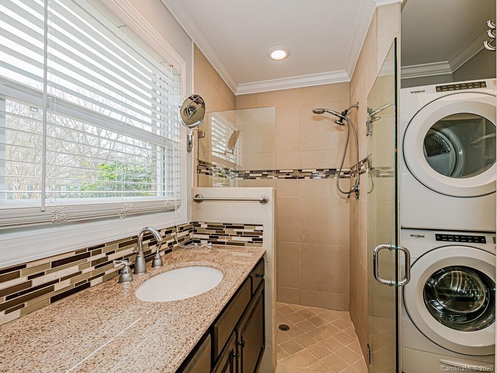5706 Telfair Road Charlotte, NC 28210 - Photo 21 of 37 a bathroom with a sink a washer and dryer