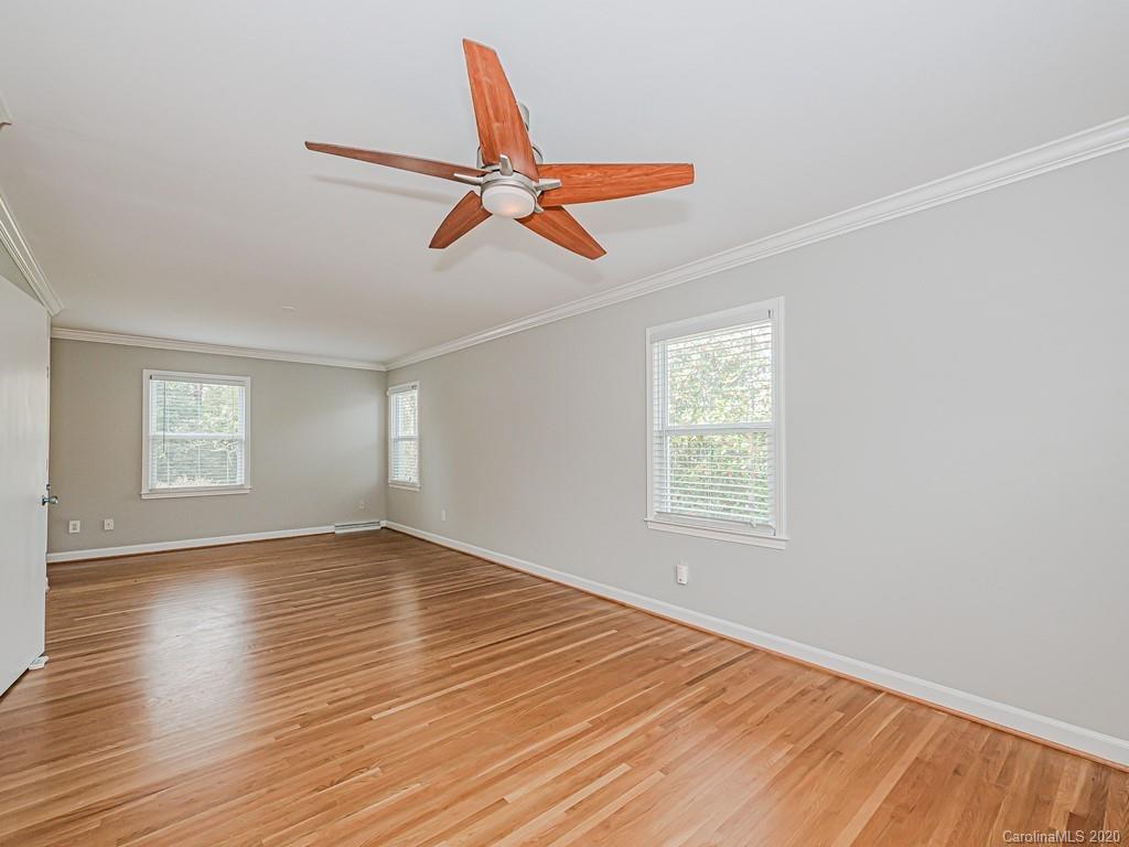 5706 Telfair Road Charlotte, NC 28210 - Photo 24 of 37 a view of empty room with wooden floor and fan