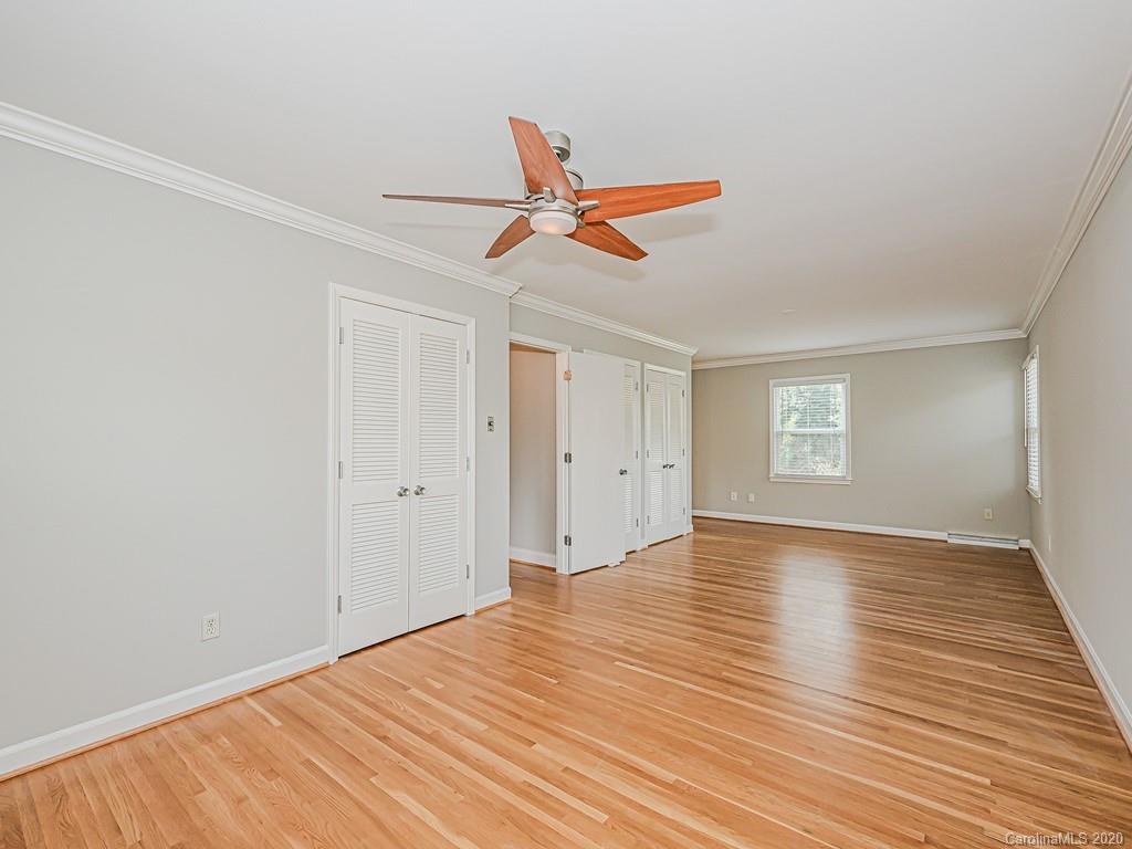 5706 Telfair Road Charlotte, NC 28210 - Photo 25 of 37 an empty room with wooden floor ceiling fan and window