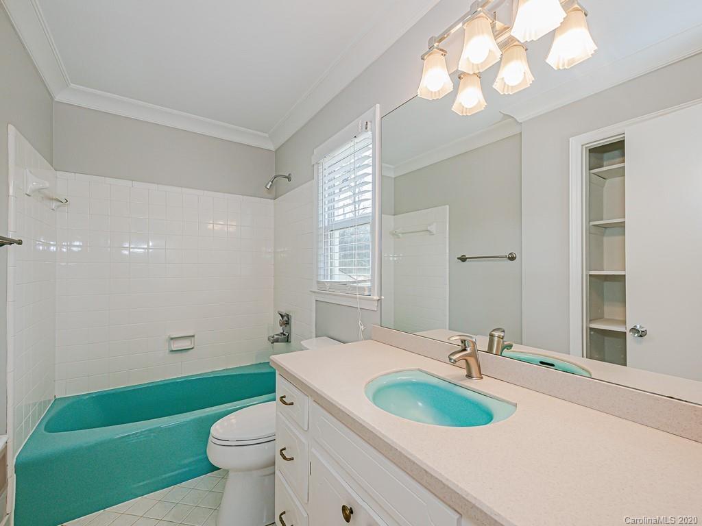 5706 Telfair Road Charlotte, NC 28210 - Photo 27 of 37 a bathroom with a toilet sink and mirror
