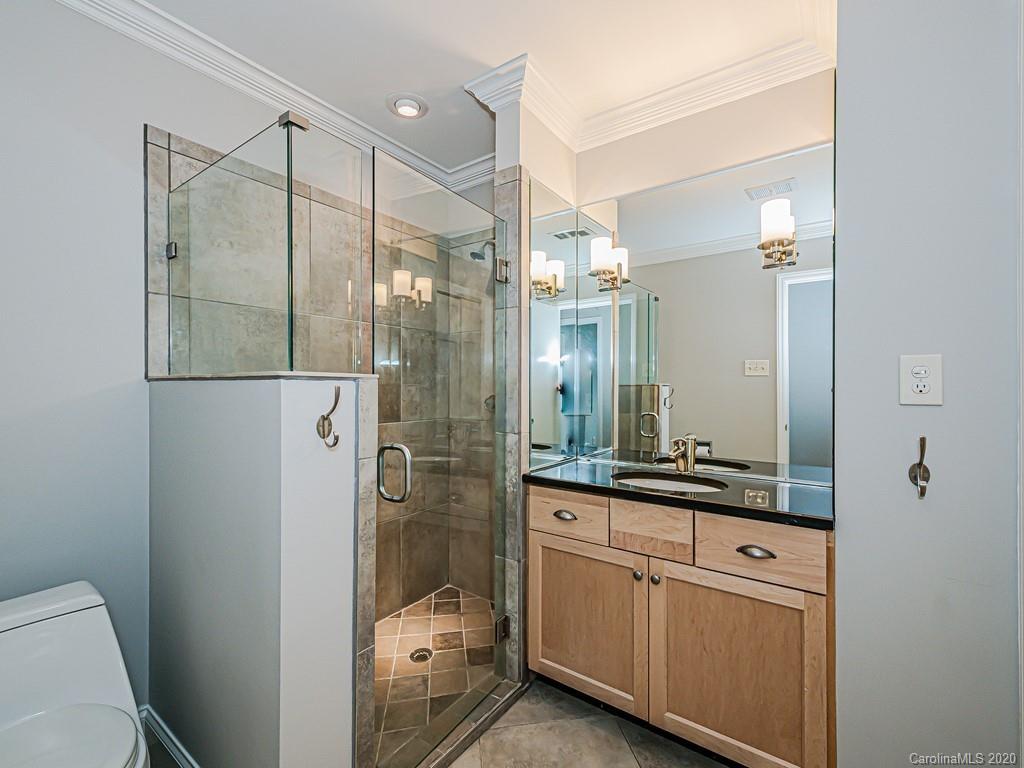 5706 Telfair Road Charlotte, NC 28210 - Photo 29 of 37 a bathroom with a shower sink and mirror