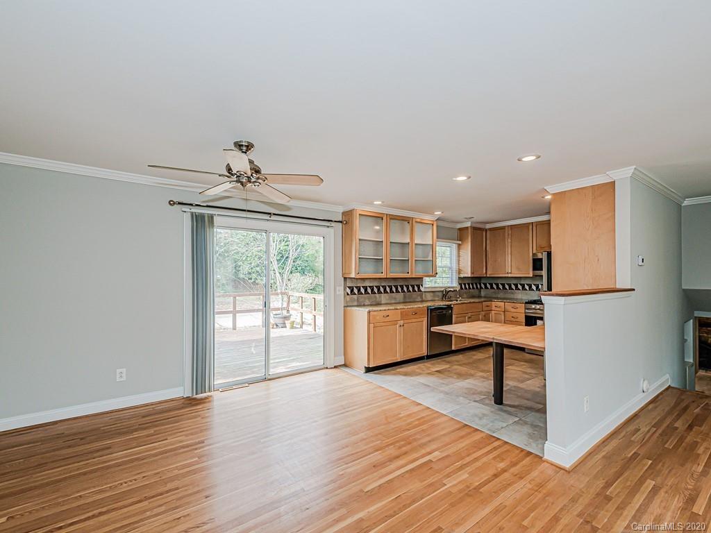 5706 Telfair Road Charlotte, NC 28210 - Photo 6 of 37 a kitchen with stainless steel appliances kitchen island wooden floor and view living room