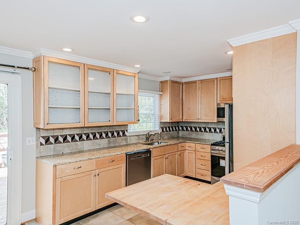 5706 Telfair Road Charlotte, NC 28210 - Photo 7 of 37 a kitchen with stainless steel appliances granite countertop a stove a sink and a microwave