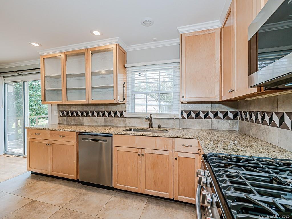 5706 Telfair Road Charlotte, NC 28210 - Photo 10 of 37 a kitchen with a sink stove and cabinets