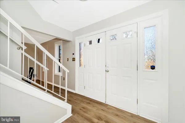 a view of an entryway with wooden floor