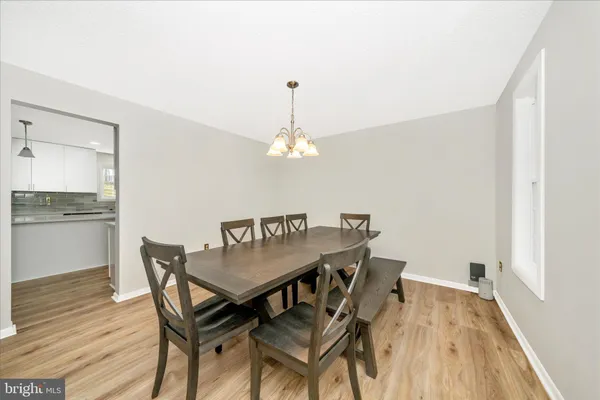 a dining room with a wooden table and chairs