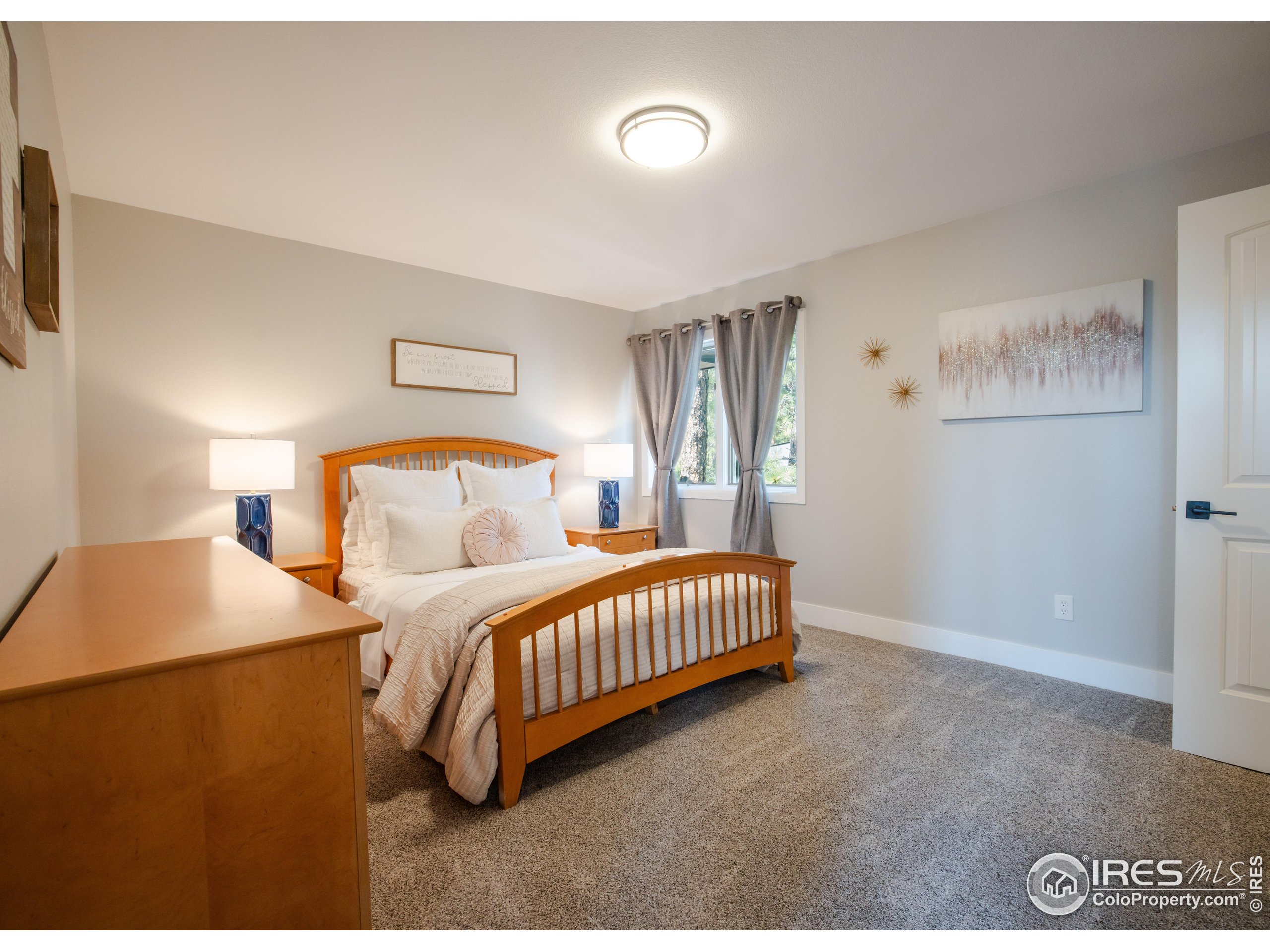 8987 Village Pines Circle Franktown, CO 80116 - Photo 13 of 31 a bedroom with a bed and a lamp