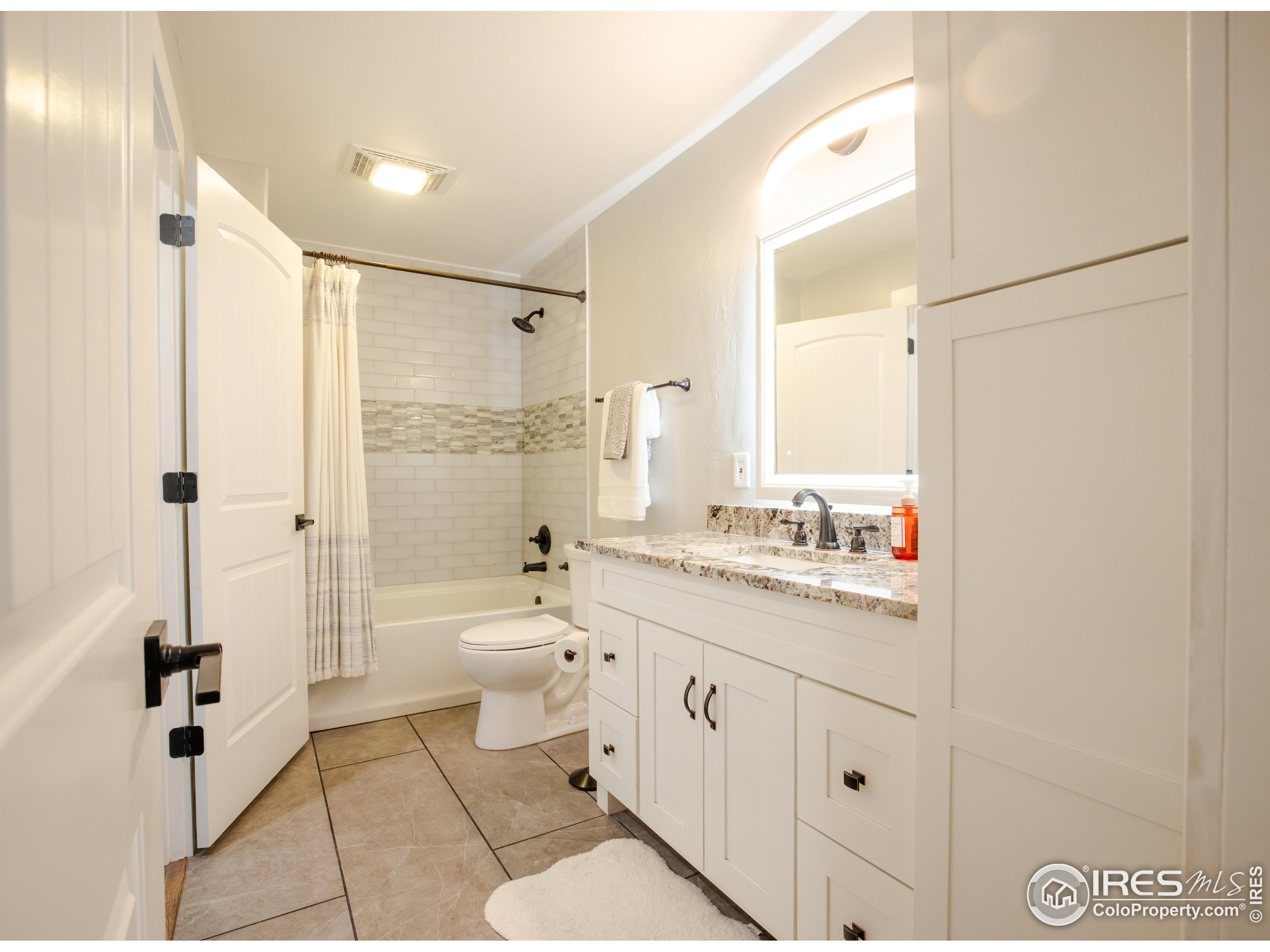 8987 Village Pines Circle Franktown, CO 80116 - Photo 14 of 31 a bathroom with a double vanity sink toilet mirror and shower