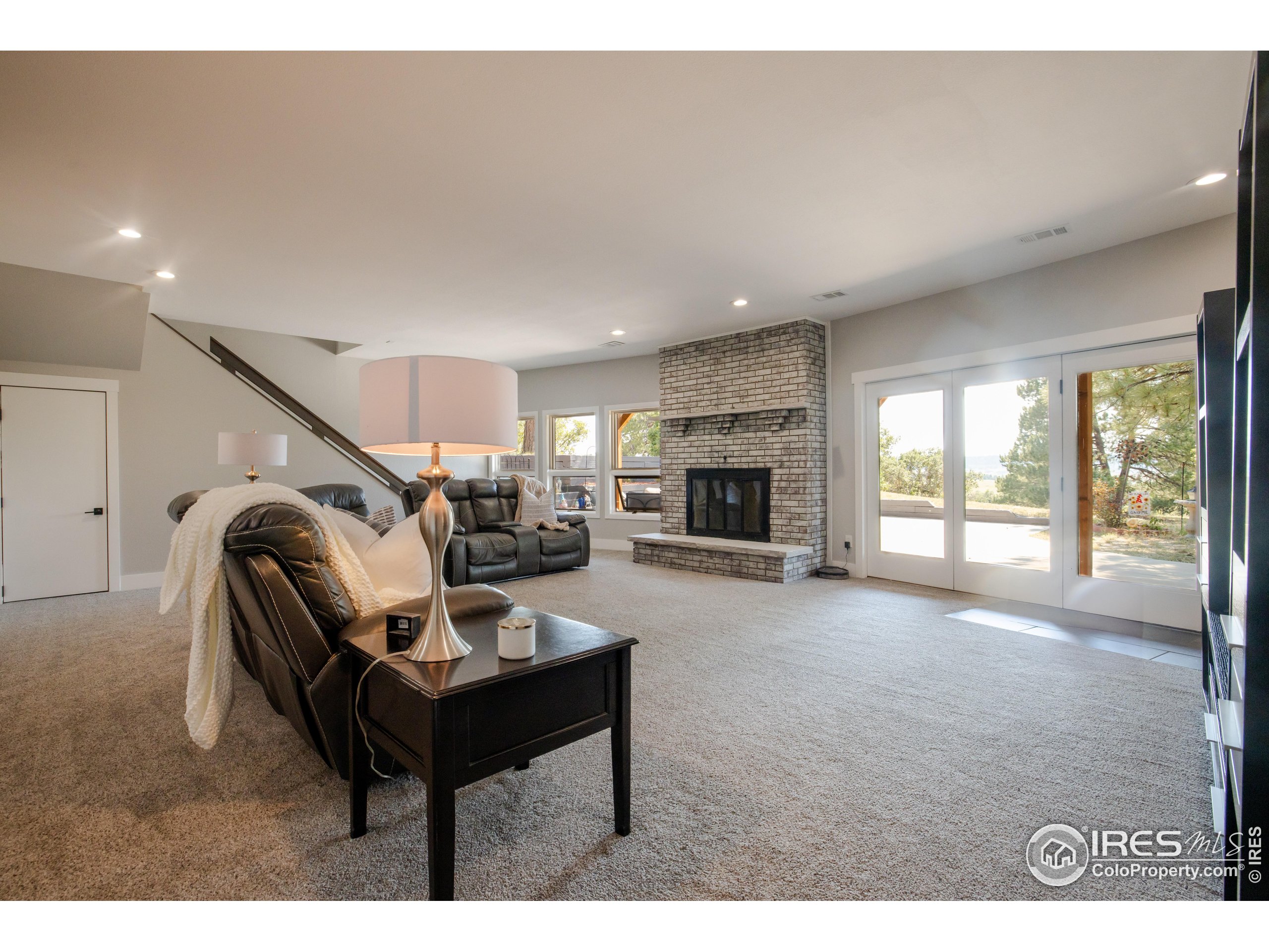 8987 Village Pines Circle Franktown, CO 80116 - Photo 17 of 31 a living room with furniture and a fireplace