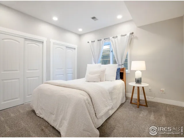 a bedroom with a bed and a lamp