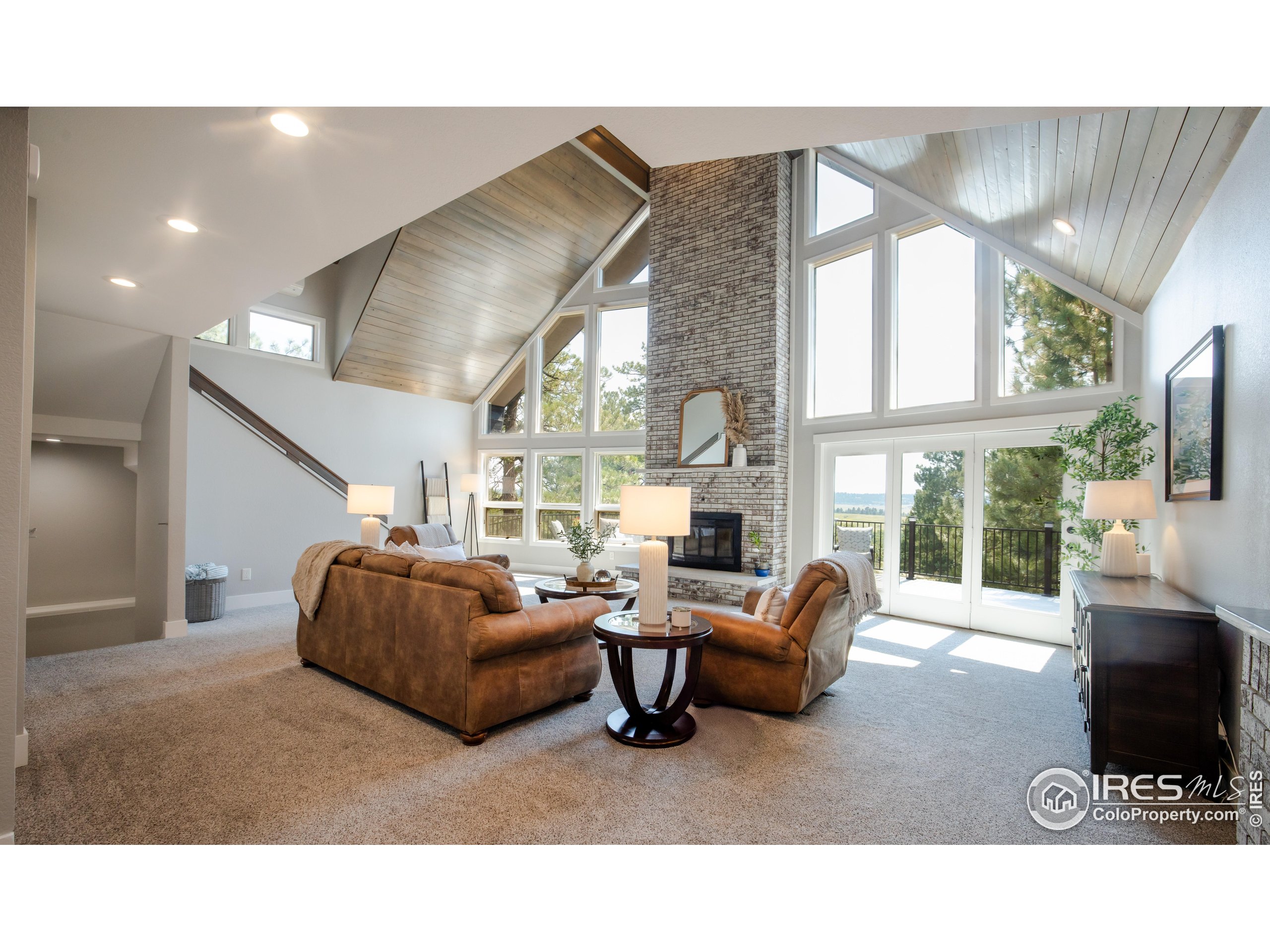 8987 Village Pines Circle Franktown, CO 80116 - Photo 2 of 31 a living room with furniture and a large window