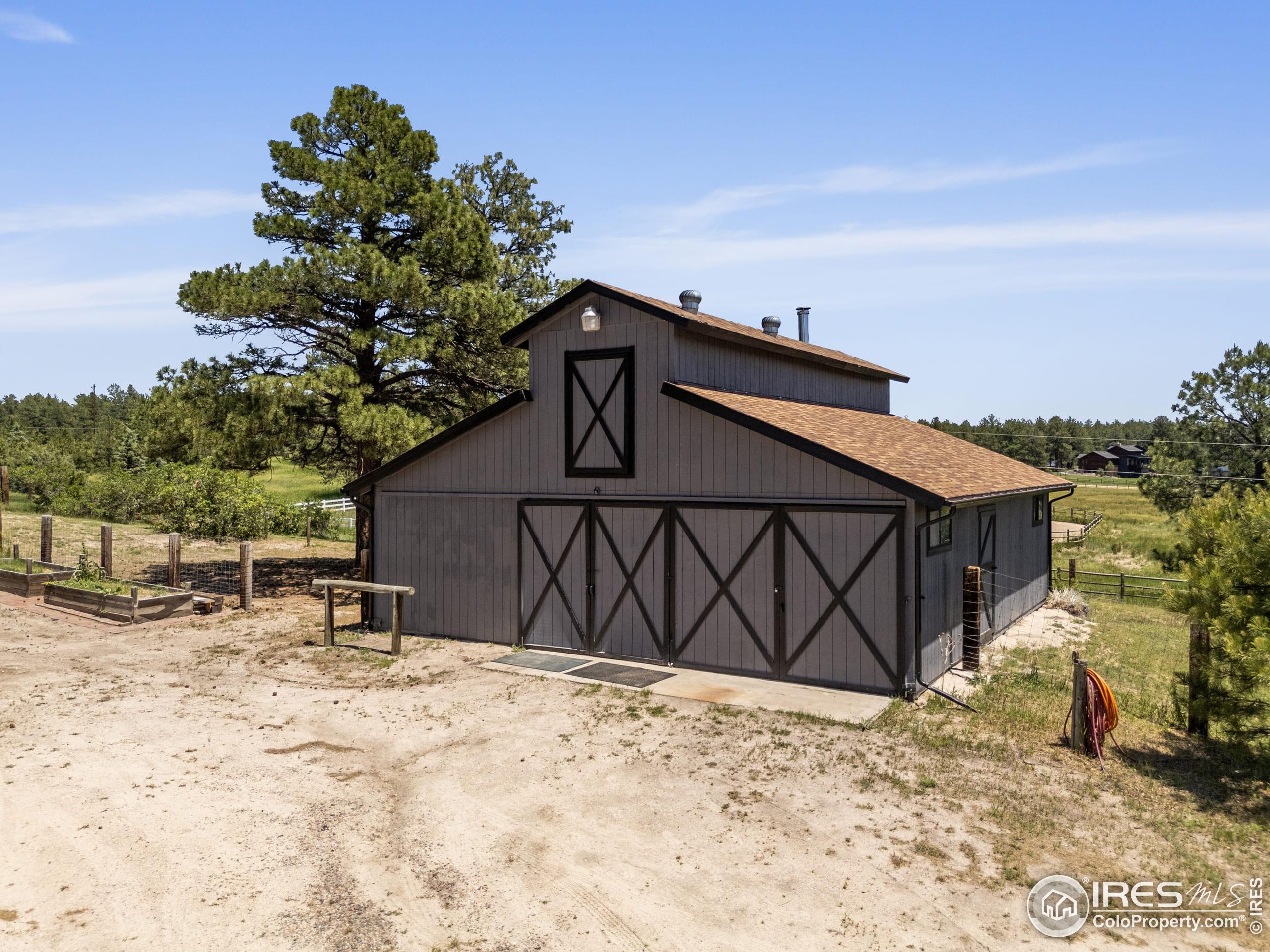 8987 Village Pines Circle Franktown, CO 80116 - Photo 21 of 31 a view of a wooden house with a large tree in front of it