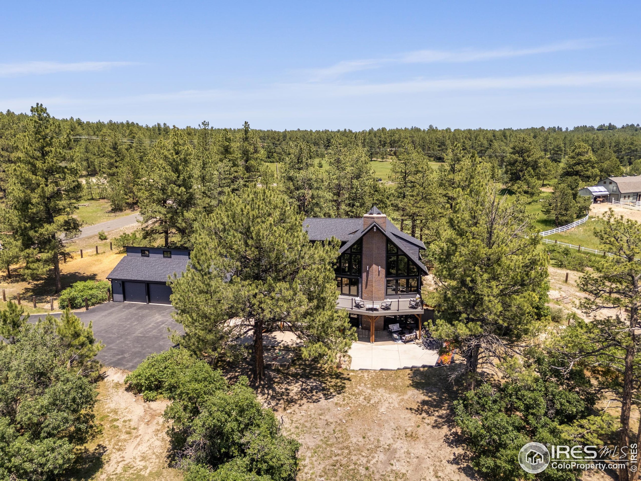 8987 Village Pines Circle Franktown, CO 80116 - Photo 25 of 31 a view of a house with a yard and mountain