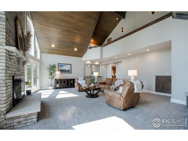 a living room with fireplace furniture and a flat screen tv